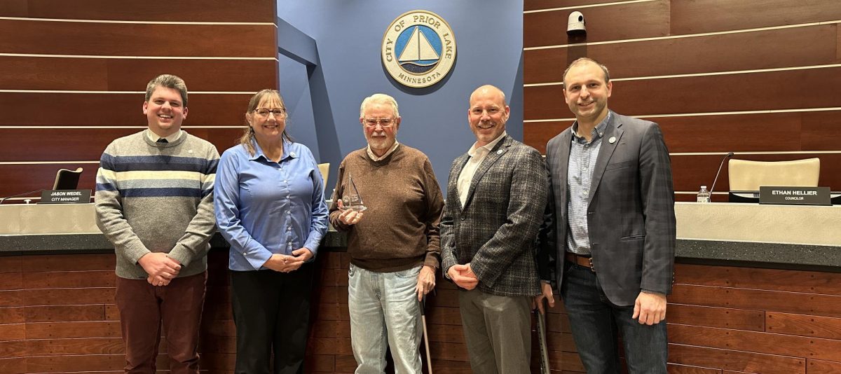 Bill Kallberg (center), nine-year member of the Prior Lake Planning Commission, was given an engraved crystal sailboat and honored by members of the city council, from left to right, Ethan Hellier, Kimberly Churchill, Zach Braid and Victor Lake. Not pictured is Mayor Kirt Briggs. Courtesy photo / City of Prior Lake