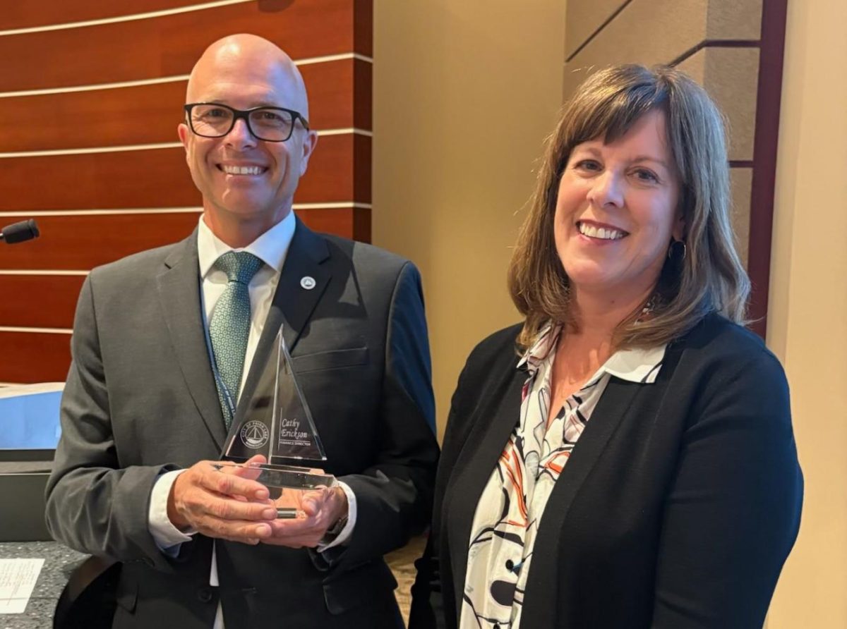 City Manager Jason Wedel presented Finance Director Cathy Erickson with an engraved glass sailboat during the Aug. 26 city council meeting.
