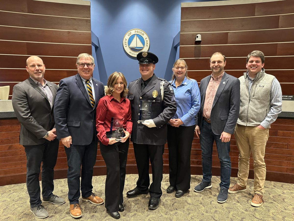 The Prior Lake City Council recognized the 2024 police department support staff person of the year, Diana Schuetz (third from left), and officer of the year, Sgt. Jake Lannon (fourth from left) at the council's meeting on Feb. 26, 2025. Courtesy photo / City of Prior Lake