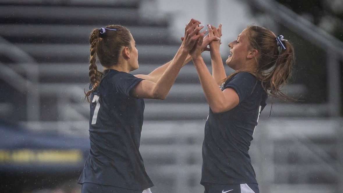 Abby Otte and Paige Layman celebrate after scoring against Apple Valley. (Photo by Caty Mawing Photography)
