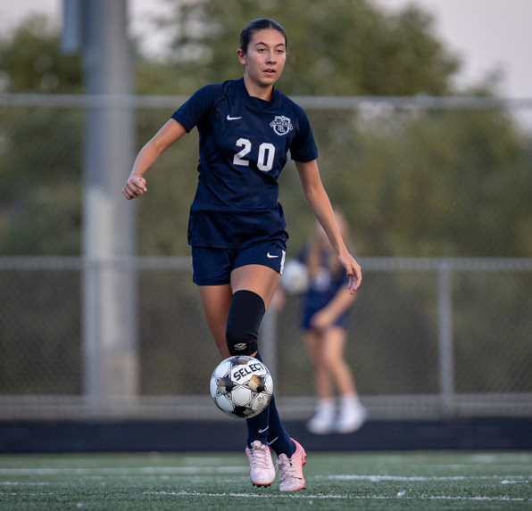 Lilly Oelrich scores her first goal while playing against Minnetonka. (Photo by Caty Mawing Photography)