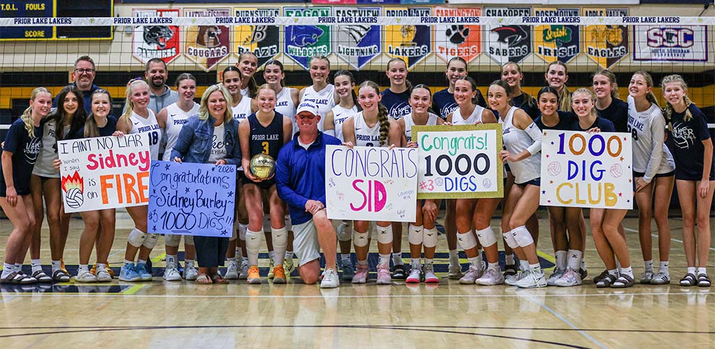 Volleyball team members rallied around Sidney Burley when she recorded her 1,000th career dig.