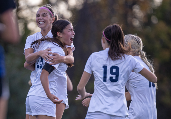 Teagan Jurek celebrates her goal against Minnetonka with teammates. (Caty Mawing Photography)