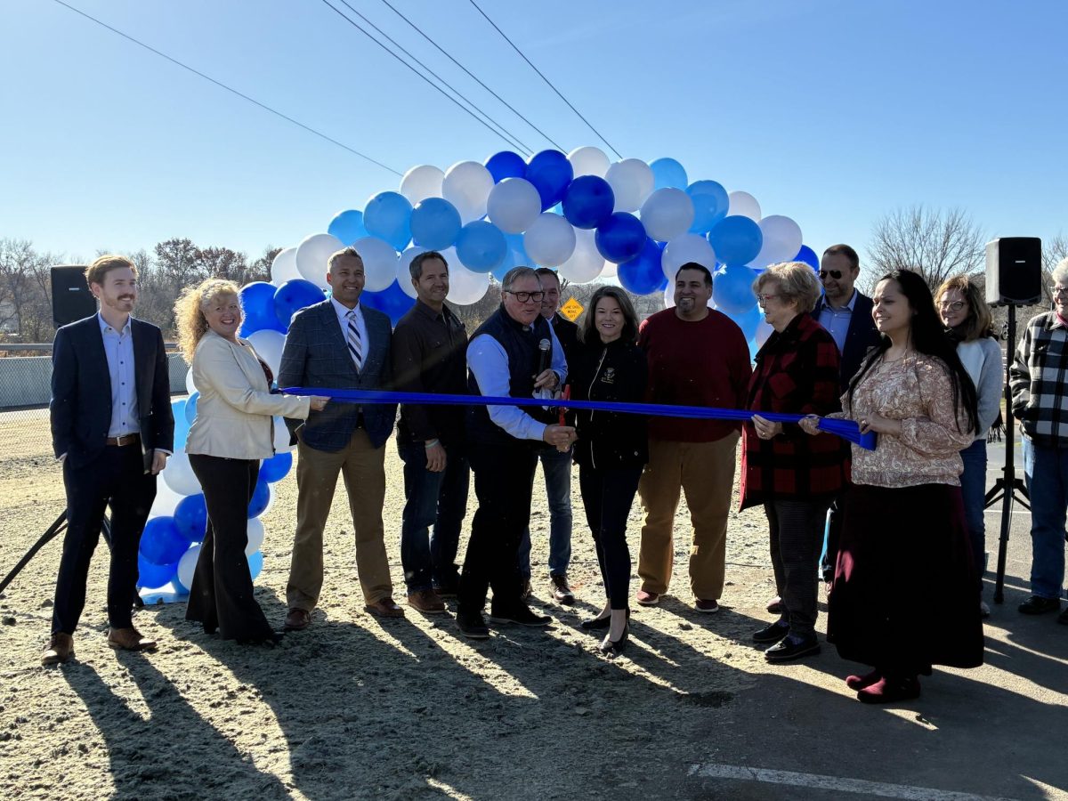 Mayor Kirt Briggs and U.S. Rep Angie Craig cut the ribbon, marking the opening of the first segment to the Highway 13 trail.
