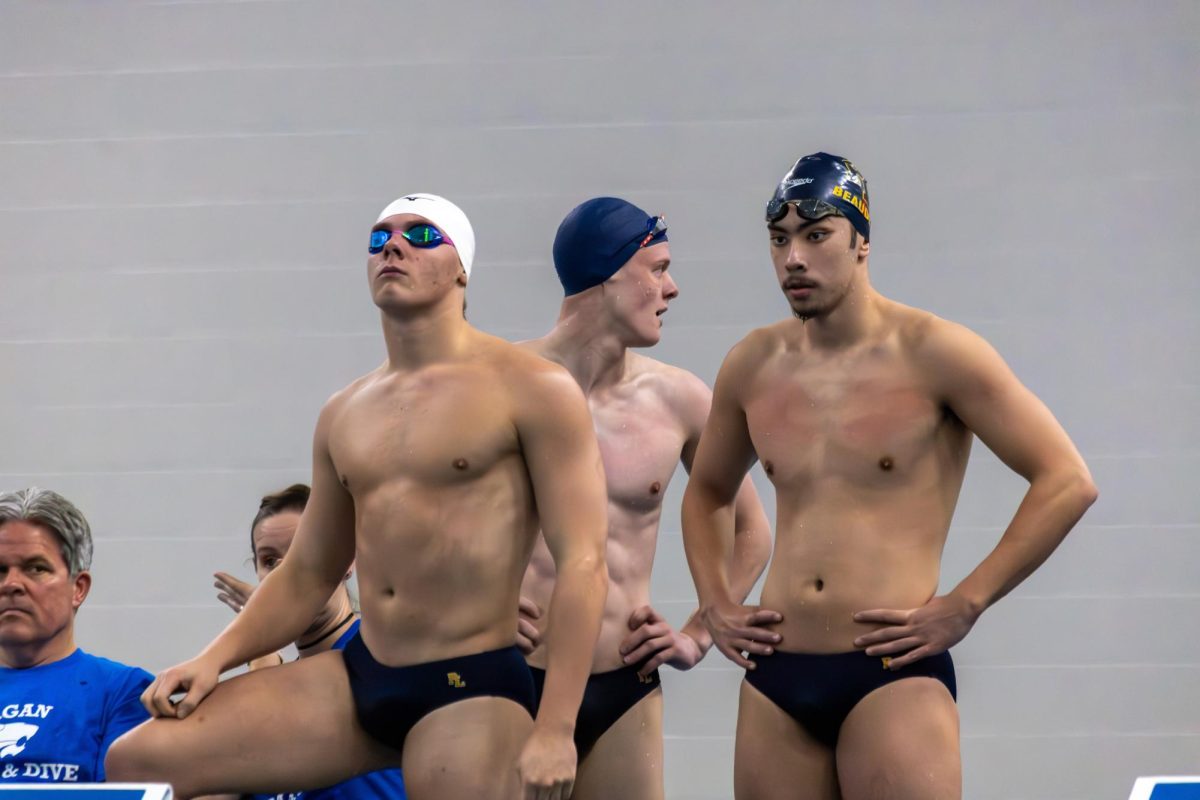 Lakers swimming and diving senior captains Owen Beaudette and  Braxton Helmers and junior captian Jamey Solt as they prepare for the 200-yard medley relay during the Dec. 5, 2025, meet against Eagan. The medley team, including junior Cameron Peterson (not pictured) broke the Eagan pool record with a time of 1:37.70 as the Lakers won their first meet in their title defense. (photo by Brayden Lillemoen)