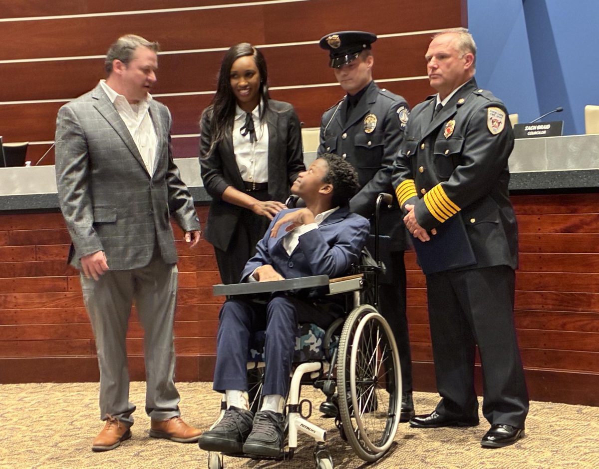 Myles Chacha was surrounded by Jared and Lulu Thompson, Officer Cody Steinhaus and Fire Chief Rick Steinhaus during the March 10 presentation.