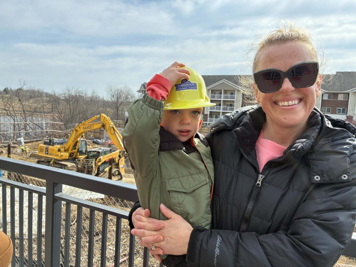 Three-year-old Spencer and his mom, Katie Reyerson, watched from the balcony of city hall as big machines moved lots of dirt on April 8.
