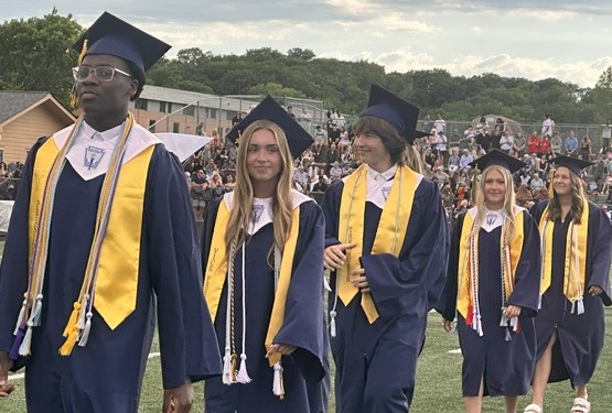 Graduates searched the crowd for family members as they walked into Dan Patch Stadium.