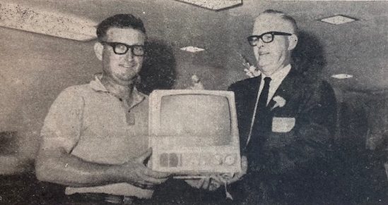 The grand prize winner at Prior Lake State Bank's open house was Don Monnens. Presenting the General Electric portable television to the winner was bank President Norman Barsness. Prize winners who received a watch were Walter Beach, Pat Farrell, Bob Klehr and Mrs. Pat Cleary. The drawing was conducted by Rep. Henry Morlock. President Barsness estimated that 350 to 400 people attended the open house.