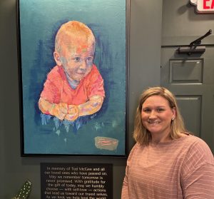 A painting of her son, Ted, was gifted to Janet McGee and hangs in a prominent spot within the local business.
